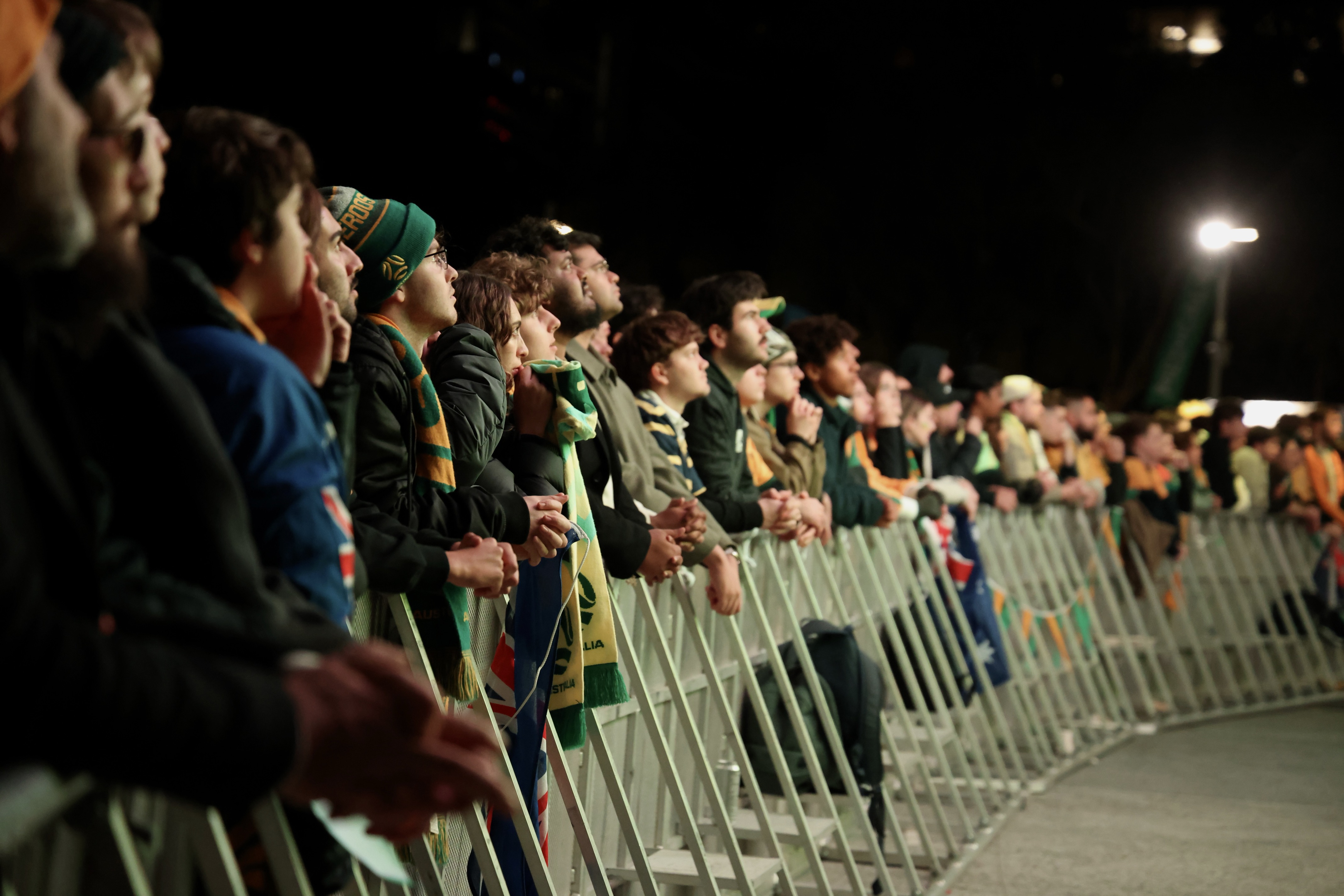 Socceroos fans lining up at a barricade