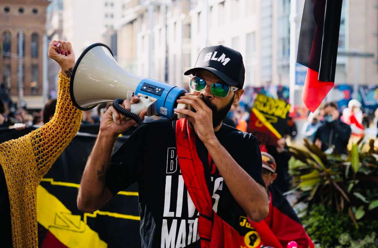 A man with a loud speaker at a protest