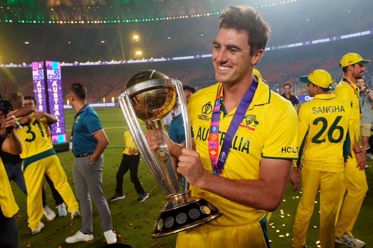 Australia's captain Pat Cummins poses for a photograph with the trophy