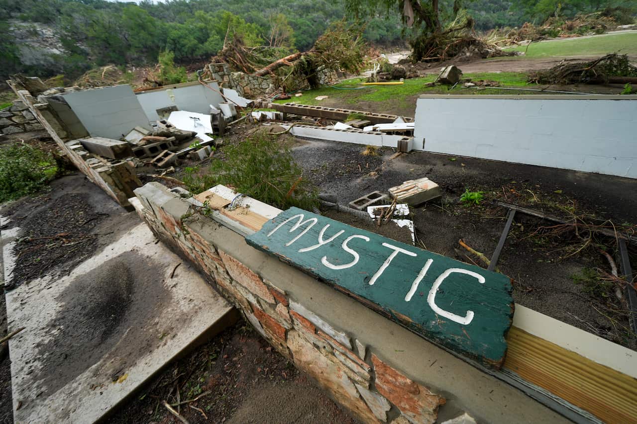 A Camp Mystic sign is seen near the entrance to the establishment along the banks of the Guadalupe River 