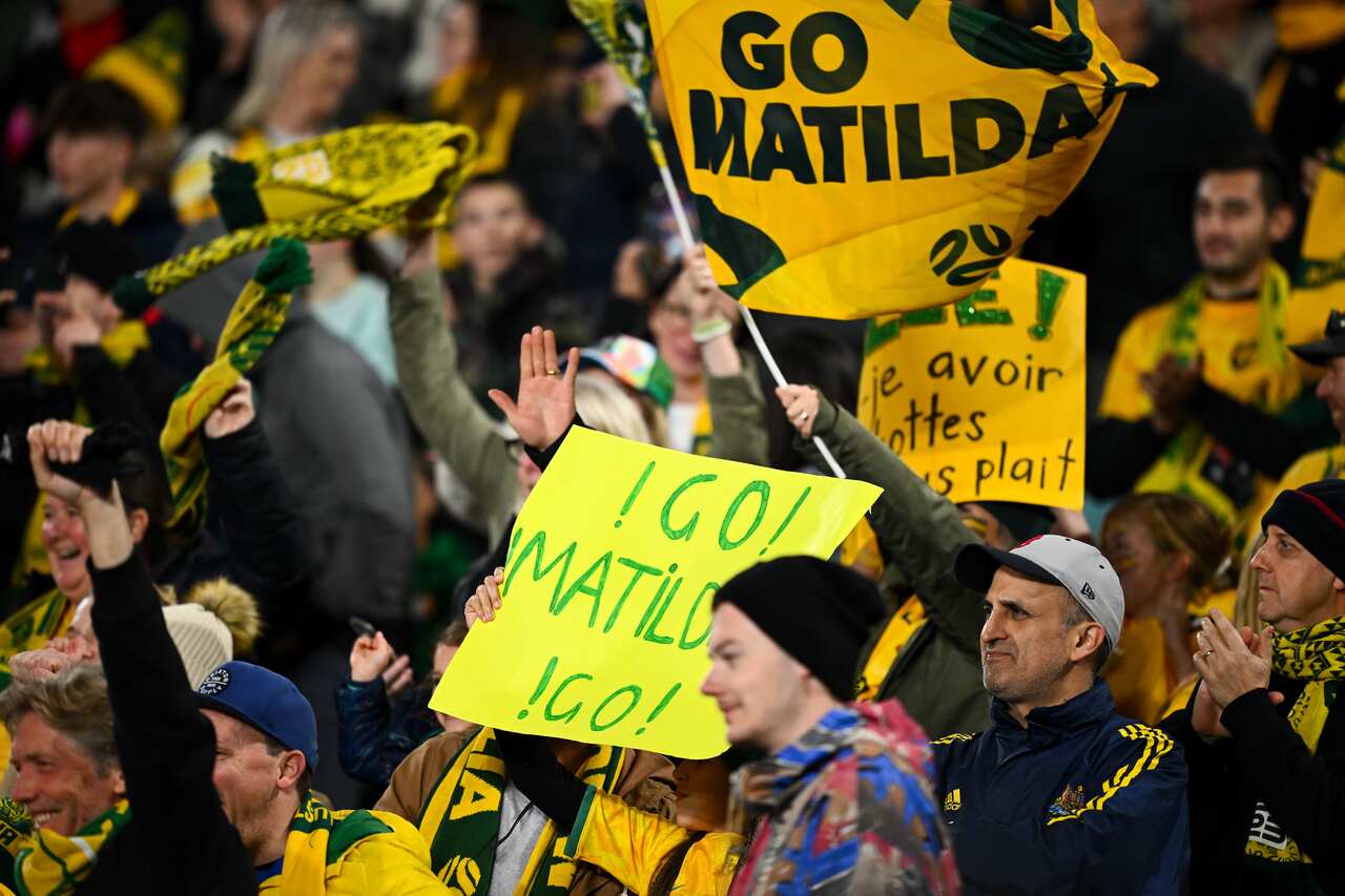 Matildas fans with banners in the crowd