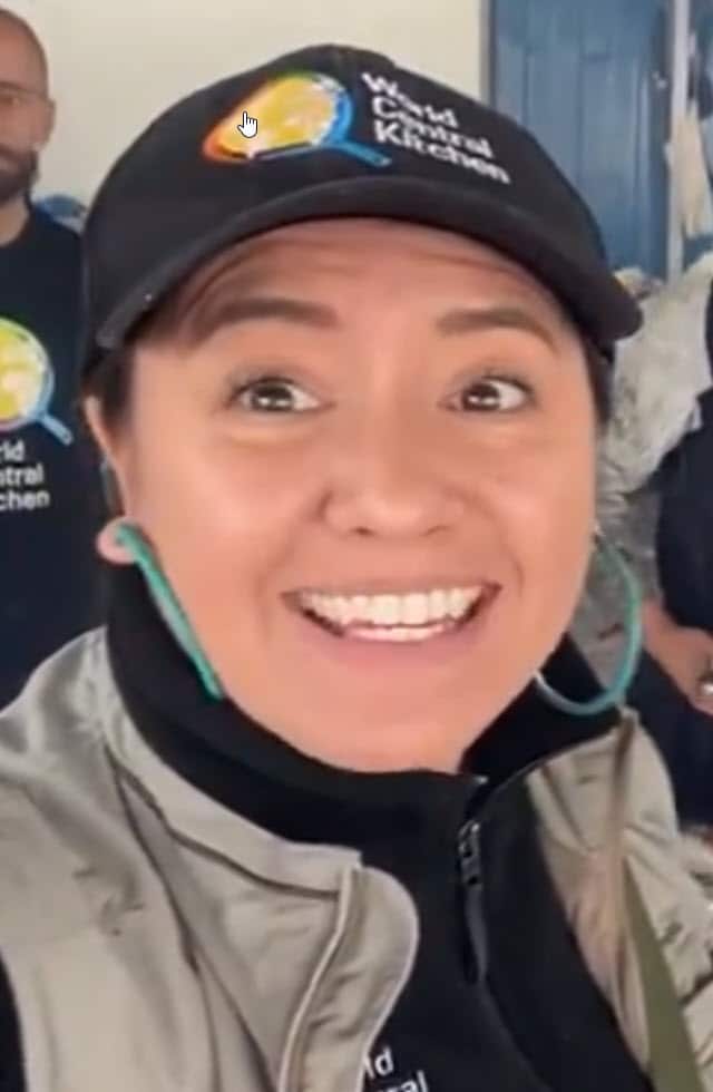 A woman in a cap, smiling at the camera