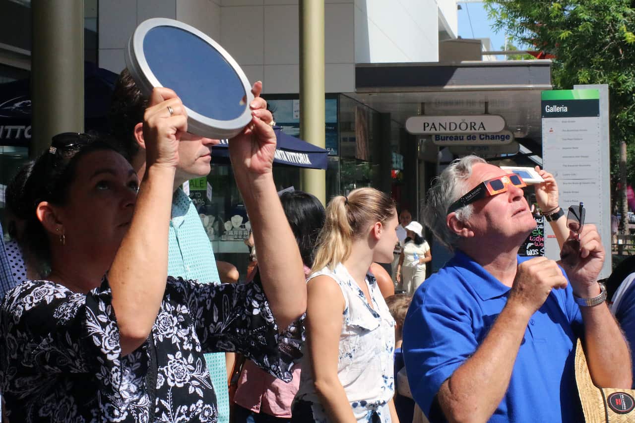 People observe a solar eclipse in Darwin in 2016. 