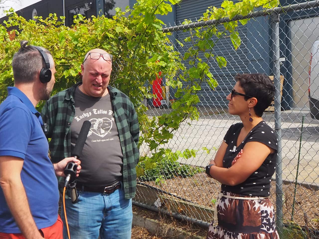 Carlo Oreglia, journalist Chris Vedelago and Dr Anna Sergi talking in the proximity of the alley where lawyer Pino Acquaro was murdered in 2016.