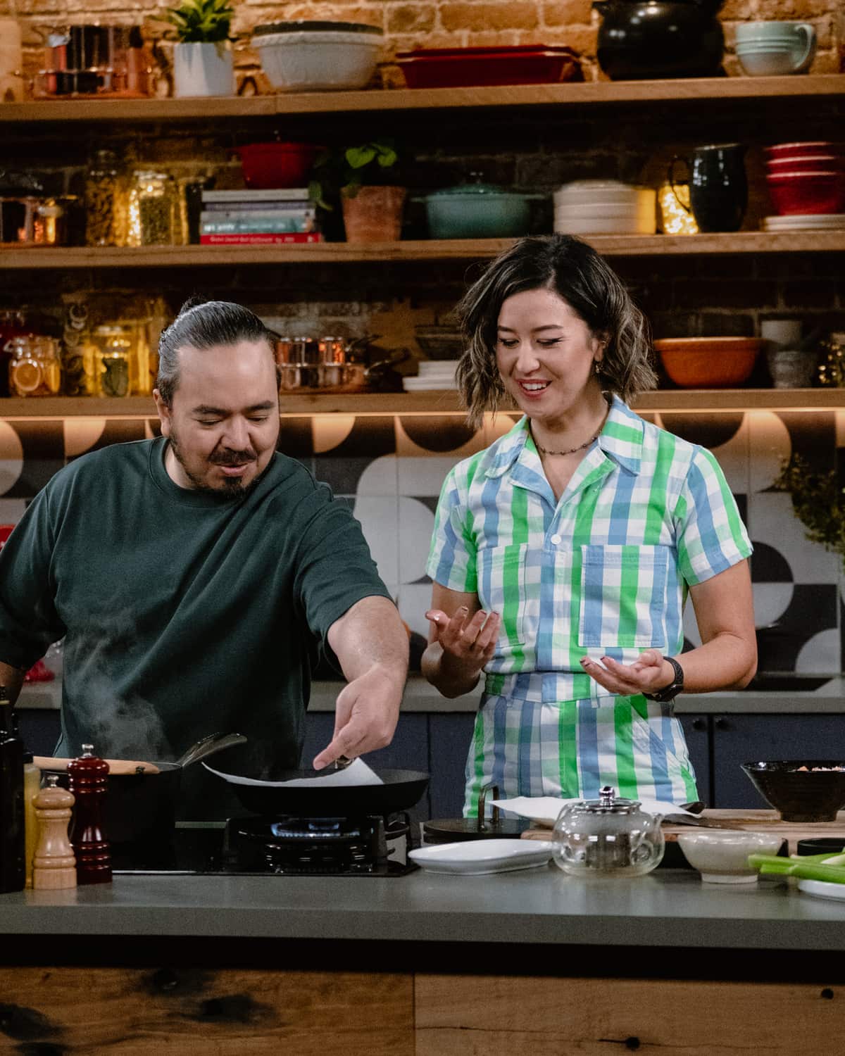 Nina Oyama (right) cooking on a stove top with Adam Liaw on The Cook Up.