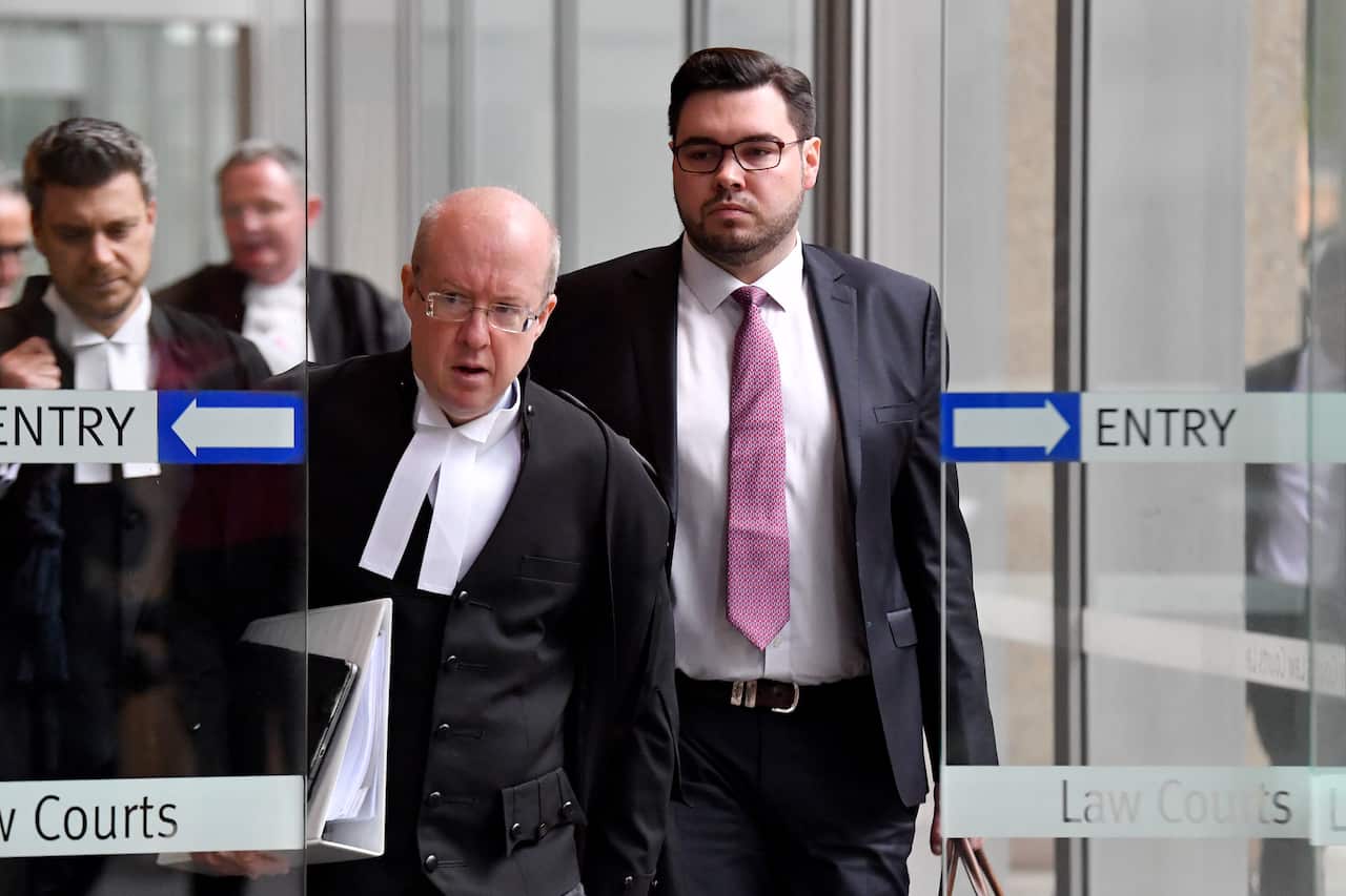 Two men walk out as doors slide open.