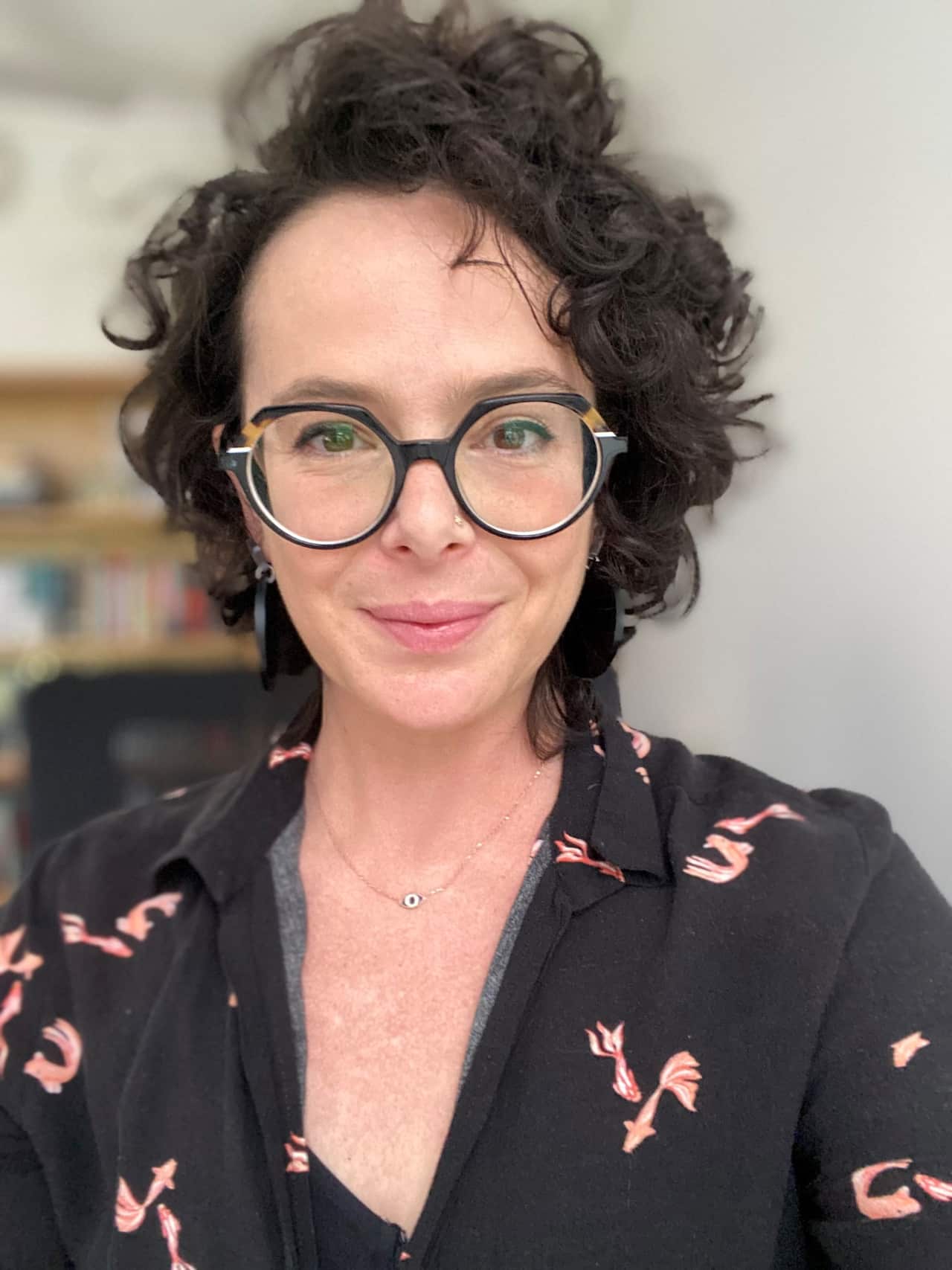 A woman with large hair and glasses.