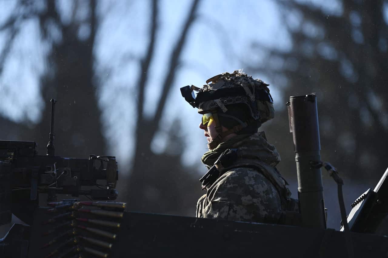  A Ukrainian soldier in an armoured vehicle