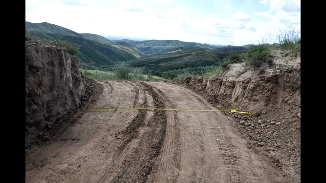 A dirt road through the damaged section of the Great Wall