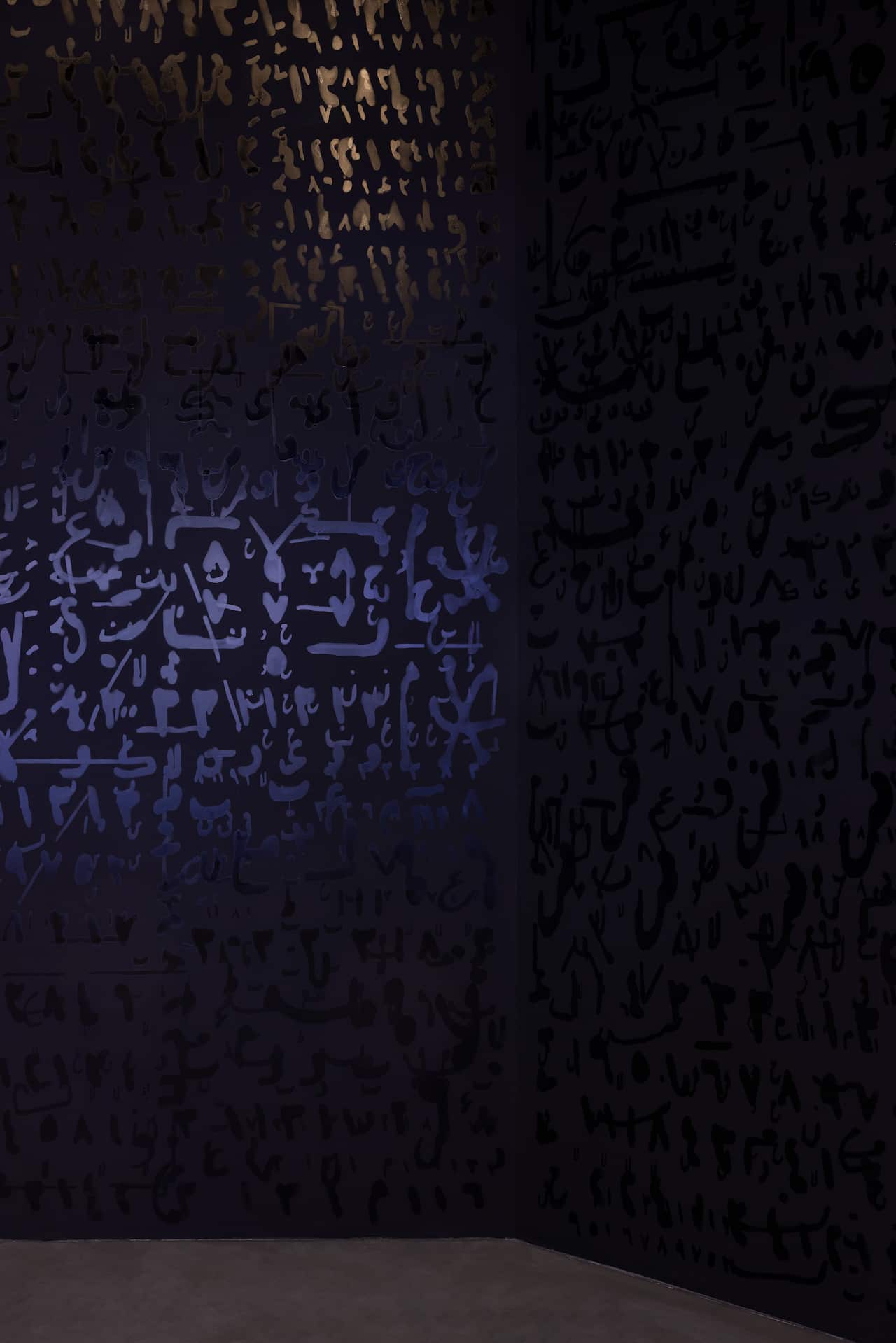 Conference of one's self, an installation artwork featuring Arabic text in reflective purple and gold colours.