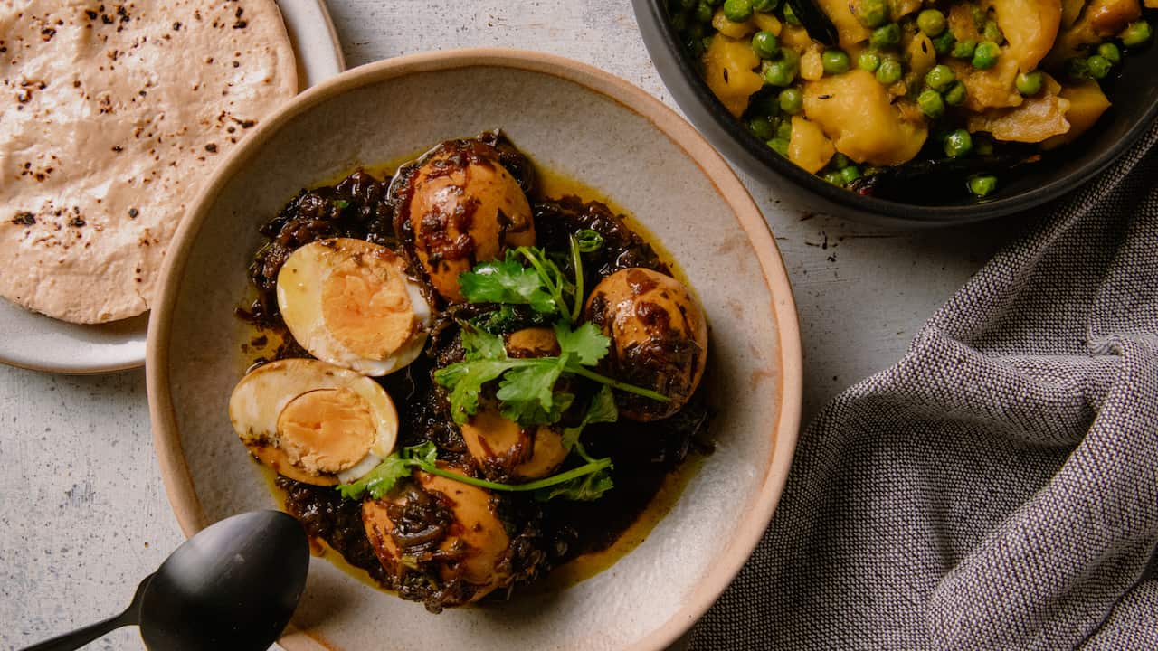 Eggs in tamarind gravy with potatoes and peas (Khatteh ande with aloo matter sabzi)