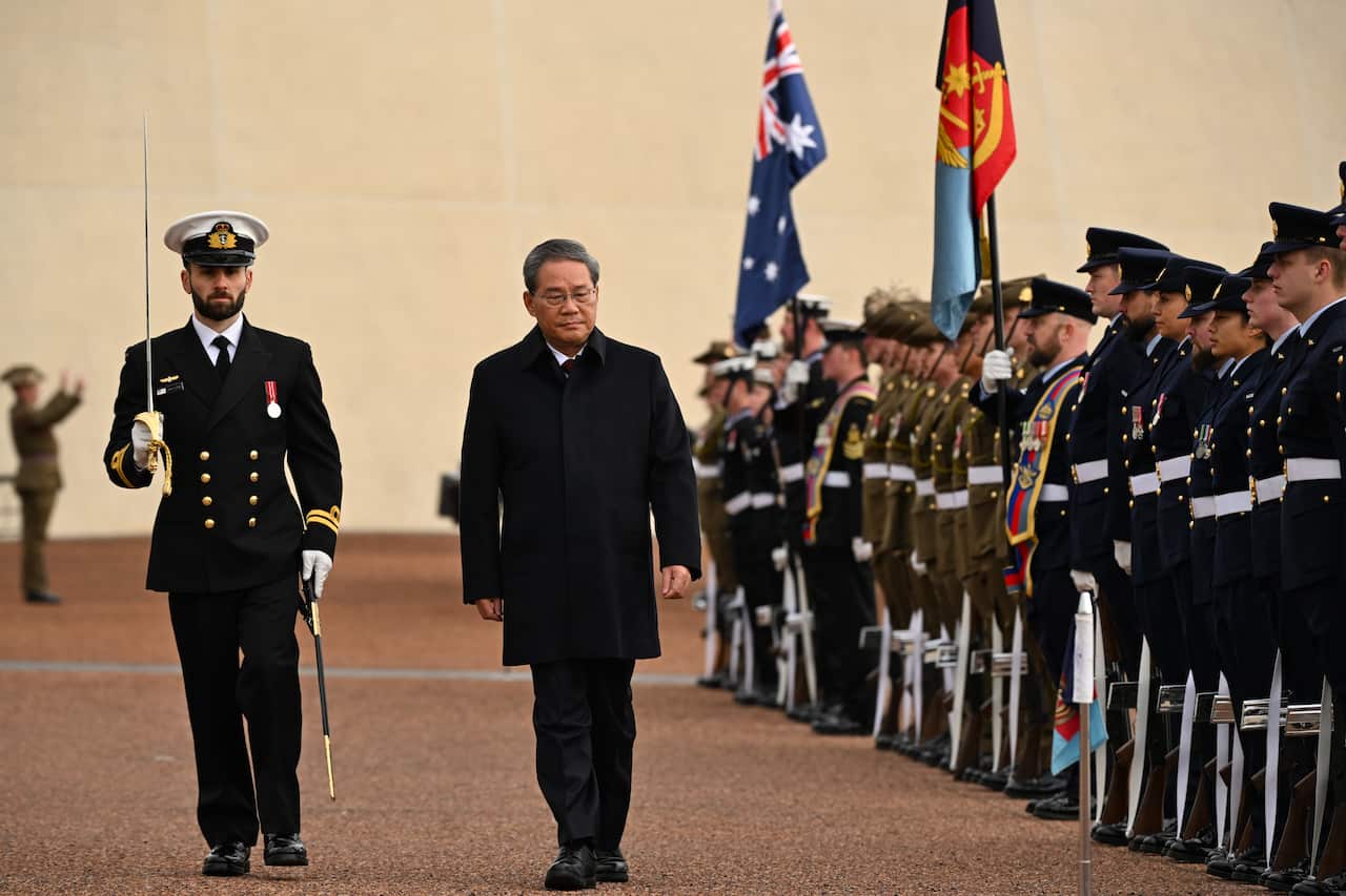 Chinese premier Li Qiang inspecting a guard of honour outside the Australian parliament house.