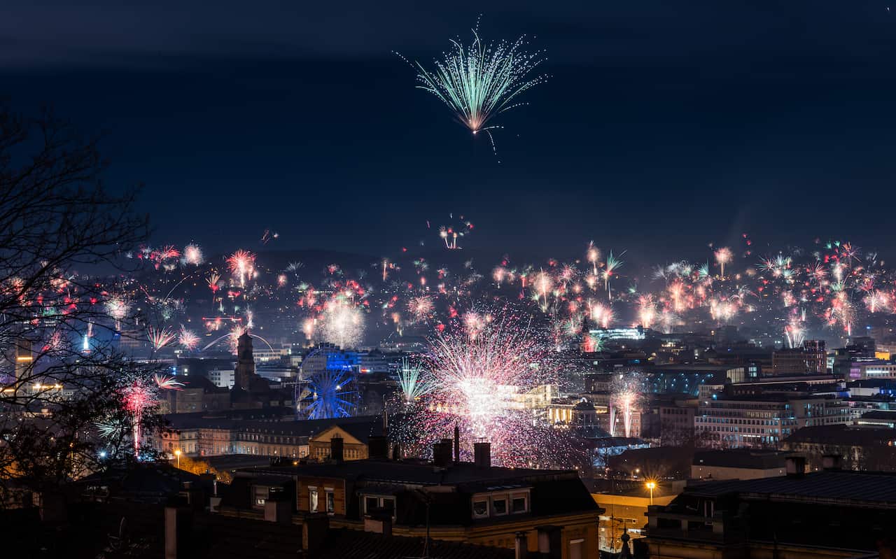 Fireworks bursting all over a city 