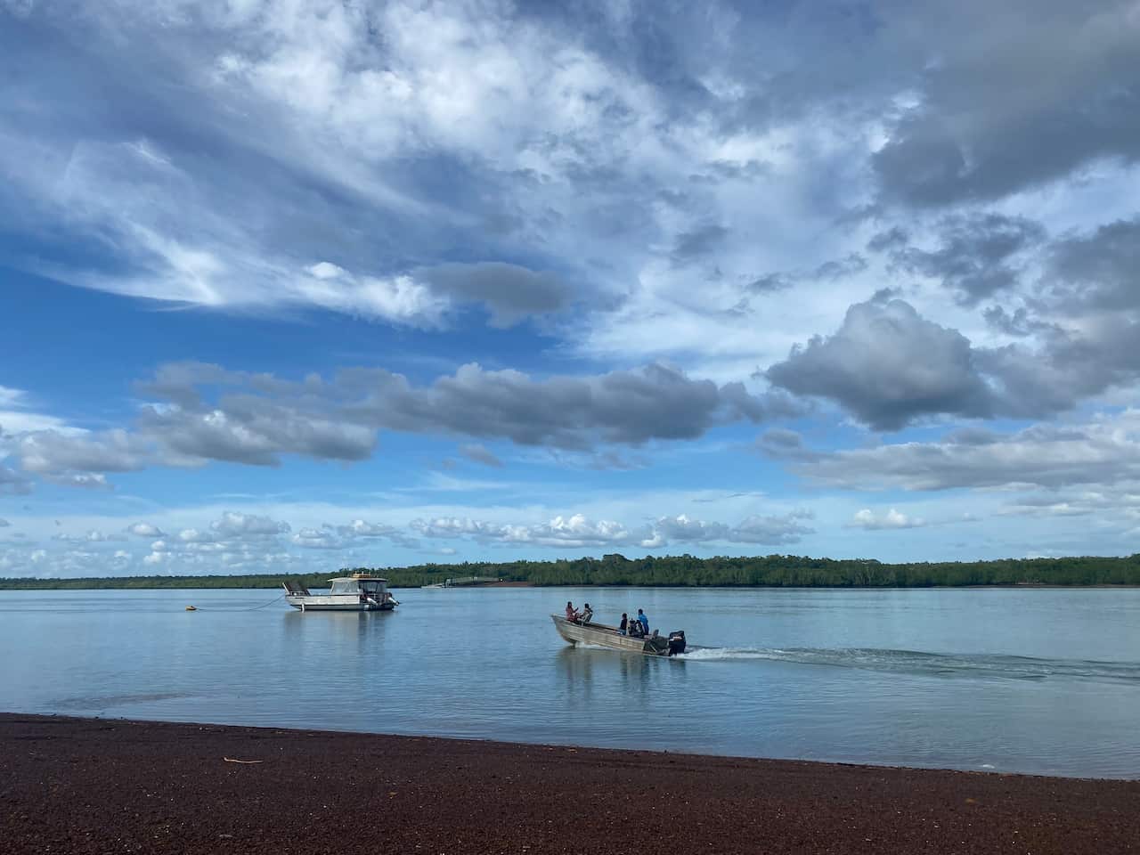 A family in a 'tinnie'. Another boat is in the distance