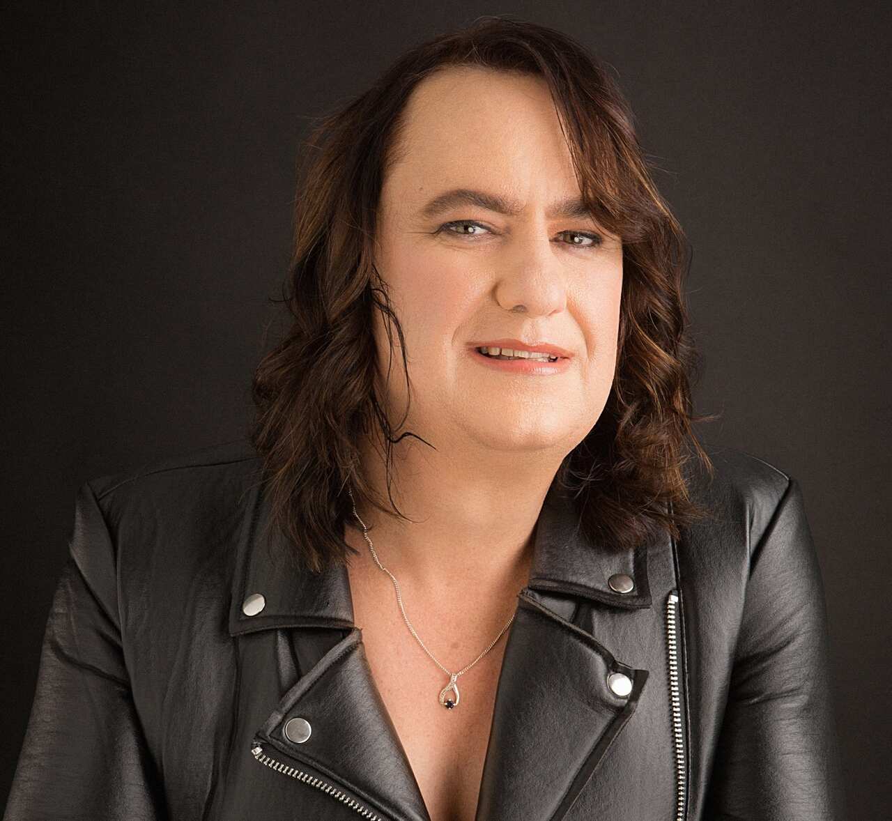 A portrait shot of Jeanene Williams wearing a denim jacket.