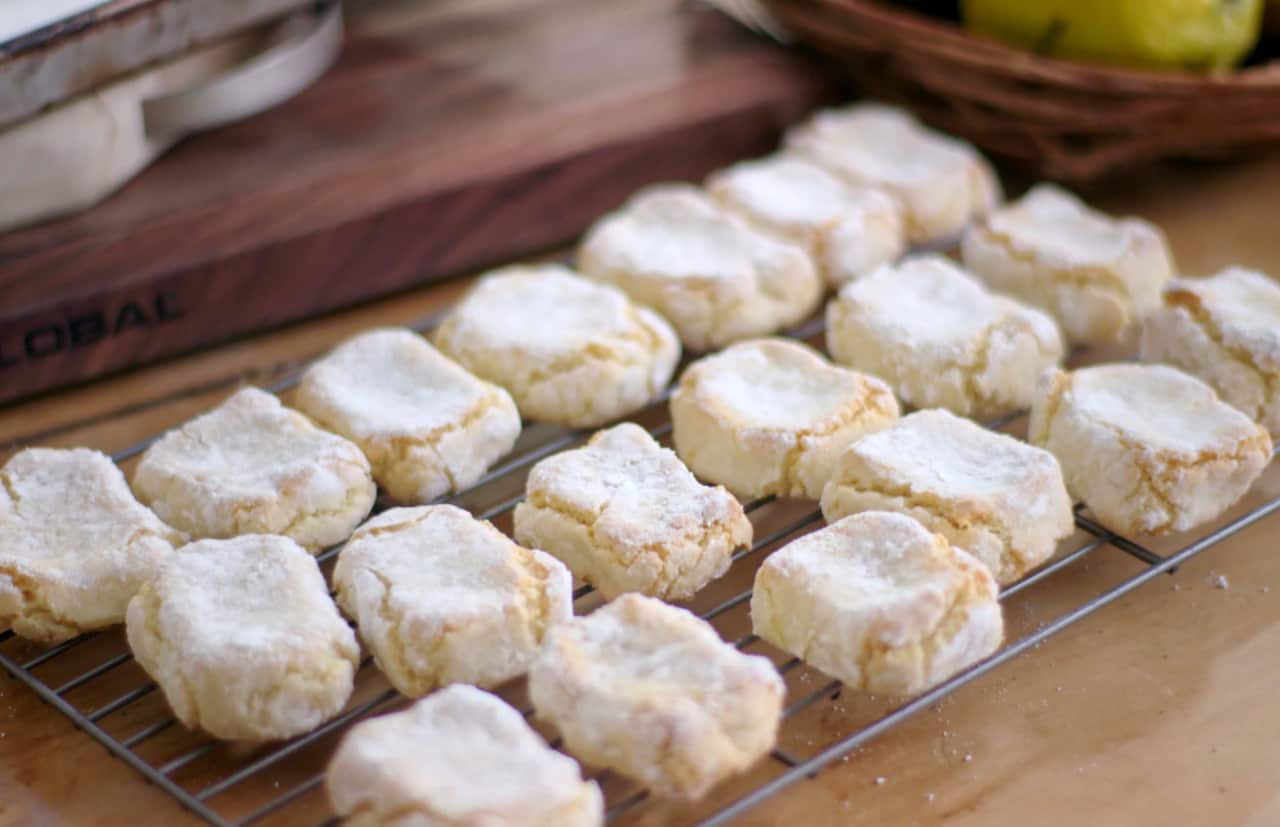 Rustic Italian almond biscuits (ricciarelli) sit on a wire rack. 