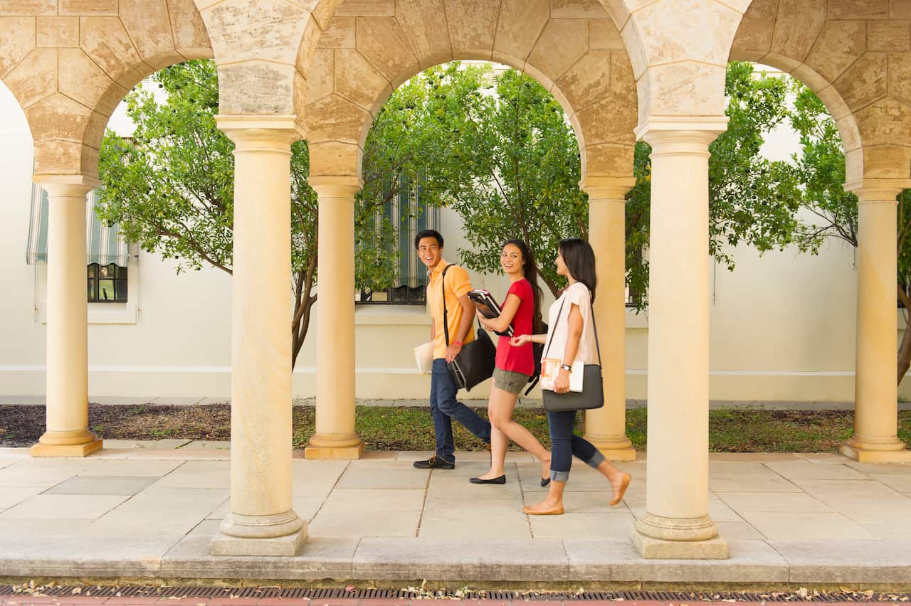 Students walking on campus at a university.