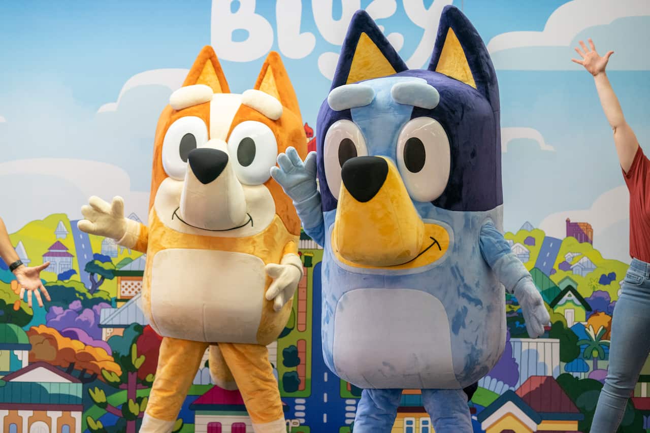 Performers dressed up as characters from the show Bluey.