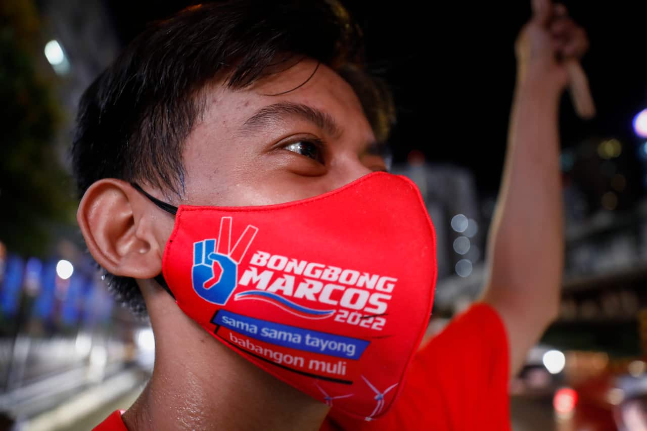 Supporters of presidential candidate Marcos Jr cheer outside his campaign headquarters.