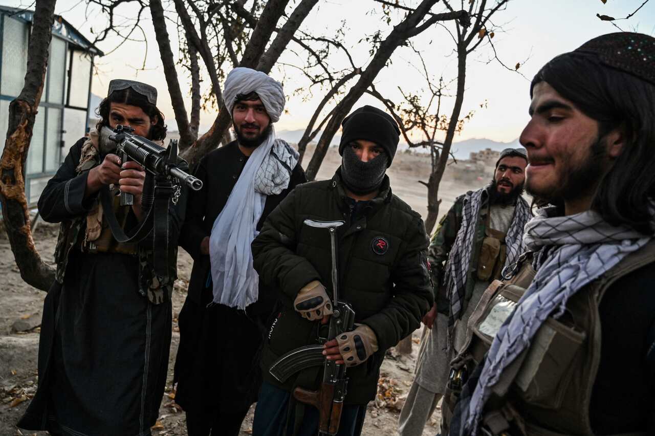 A small group of men holding guns outside.