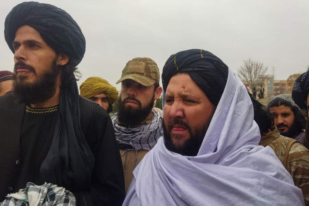 Taliban official members look during public floggings of women and men at a football stadium in Charikar city of Parwan province, Afghanistan.