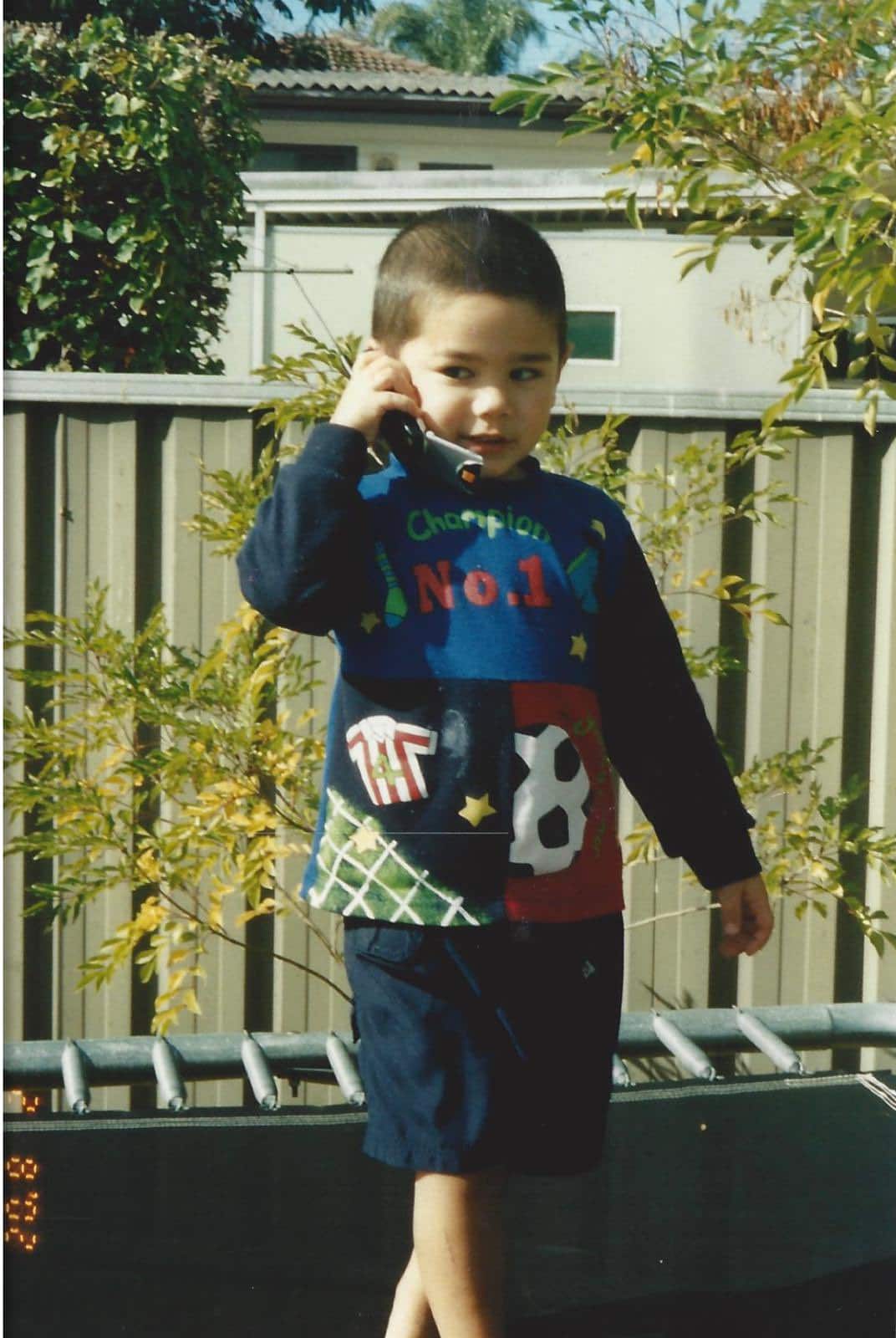Sheldon Riley on a mobile phone as a child