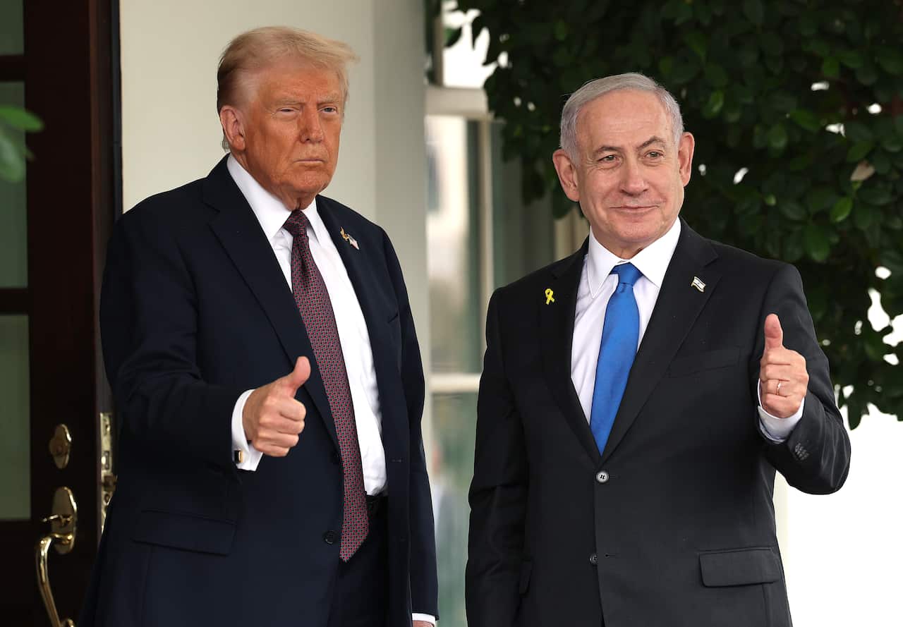 Israel's Benjamin Netanyahu stands with Donald Trump, with both men giving a thumbs up.