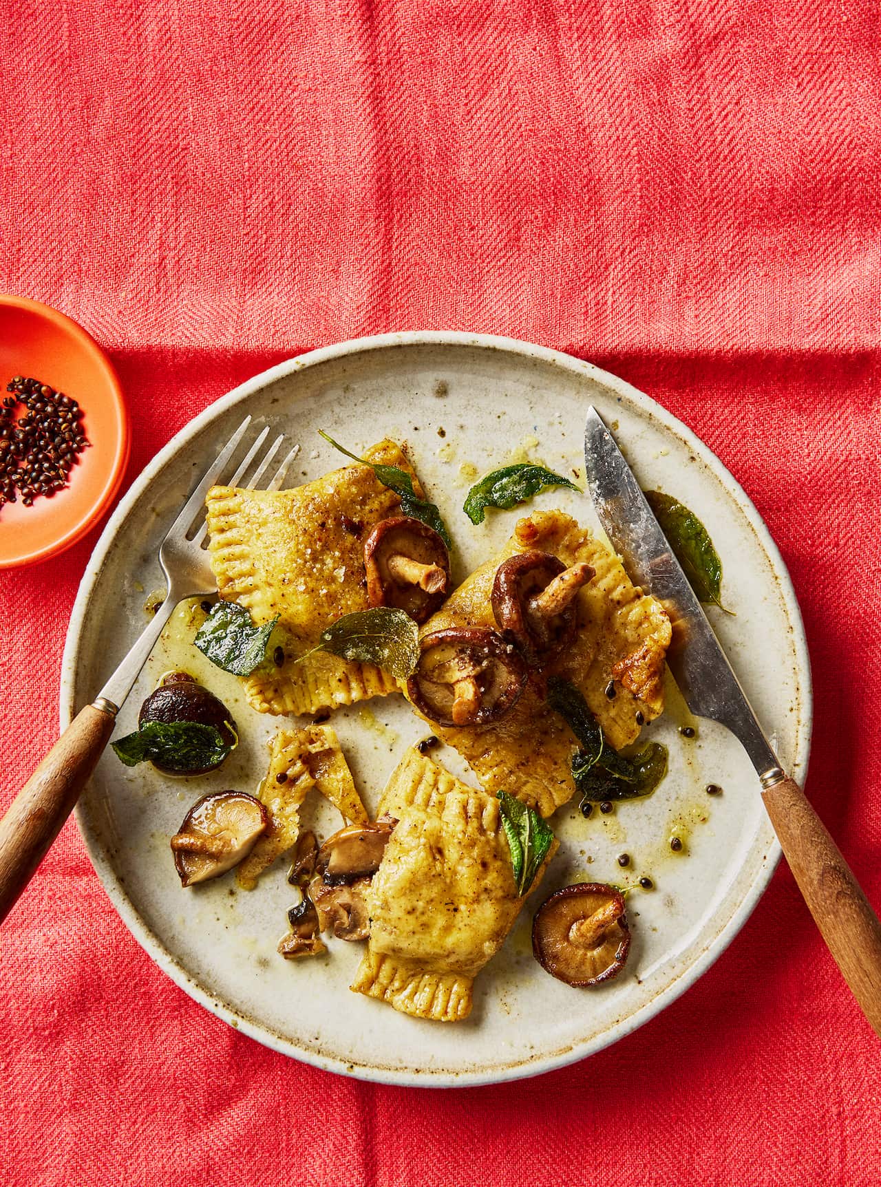 Three large ravioli and some scattered mushrooms.