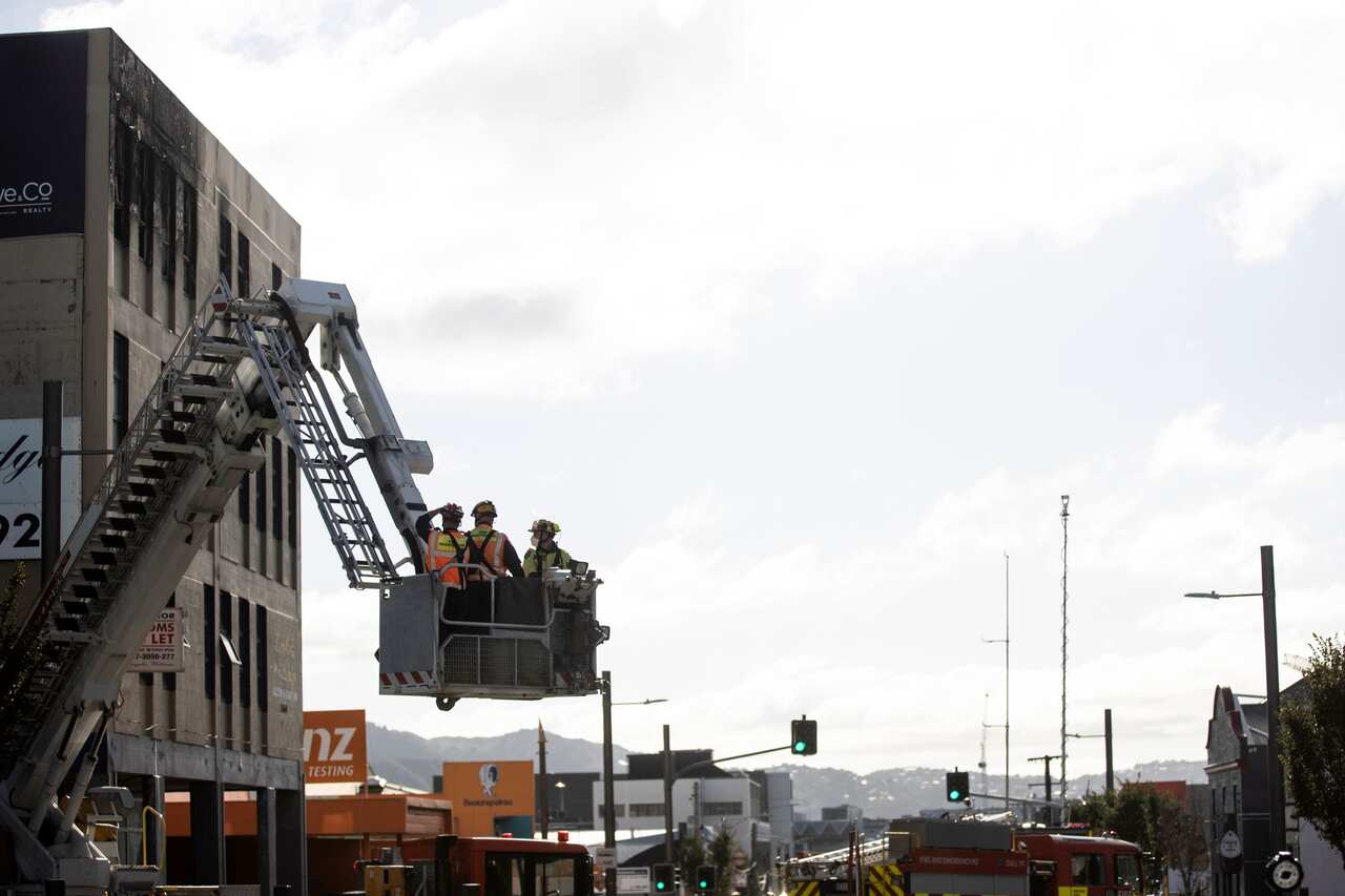 Investigators survey the scene Wednesday, May 17, 2023, after an apartment fire at Loafers Lodge in Wellington, 