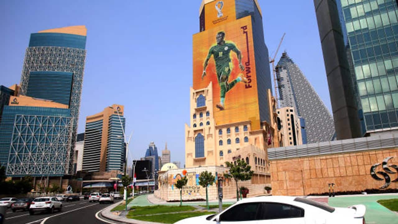 A poster of Senegal's forward Sadio Mane, whose team qualified for the FIFA 2022 World Cup, adorns a building in the Qatari capital Doha on August 16, 2022.jpg