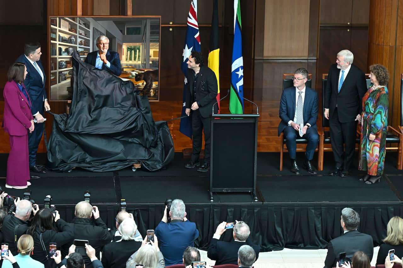 A portrait being unveiled.