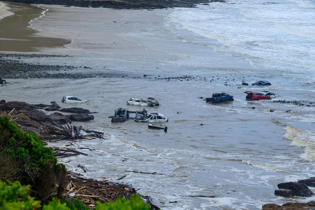 Cars washed onto a beach by flash flooding