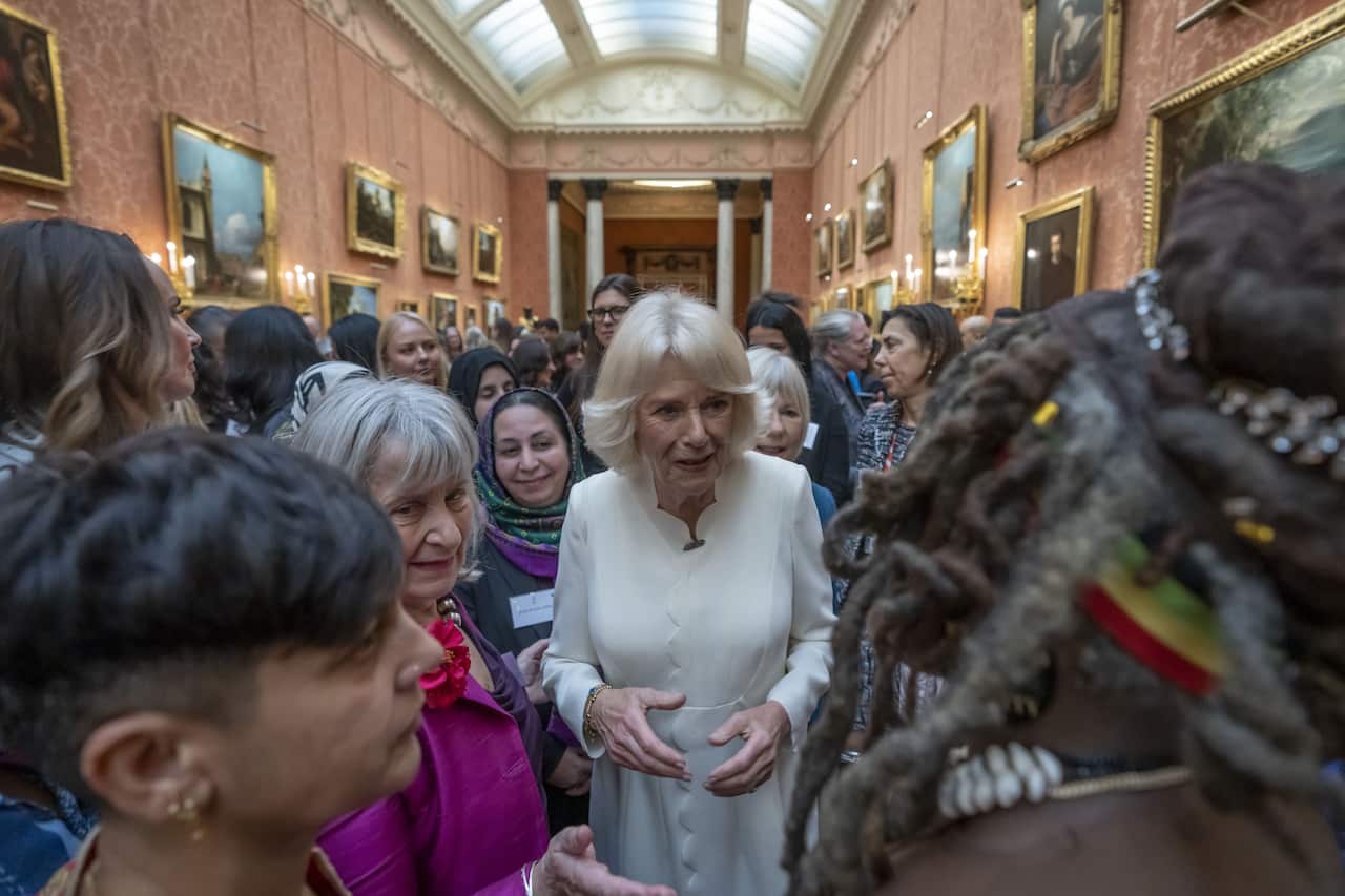 Camilla meets with women at the reception inside Buckingham Palace