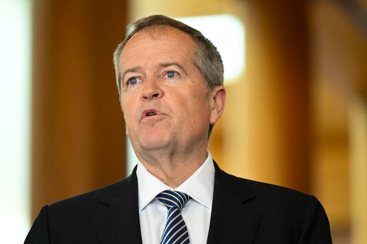 A man in a black suit jacket and white shirt.