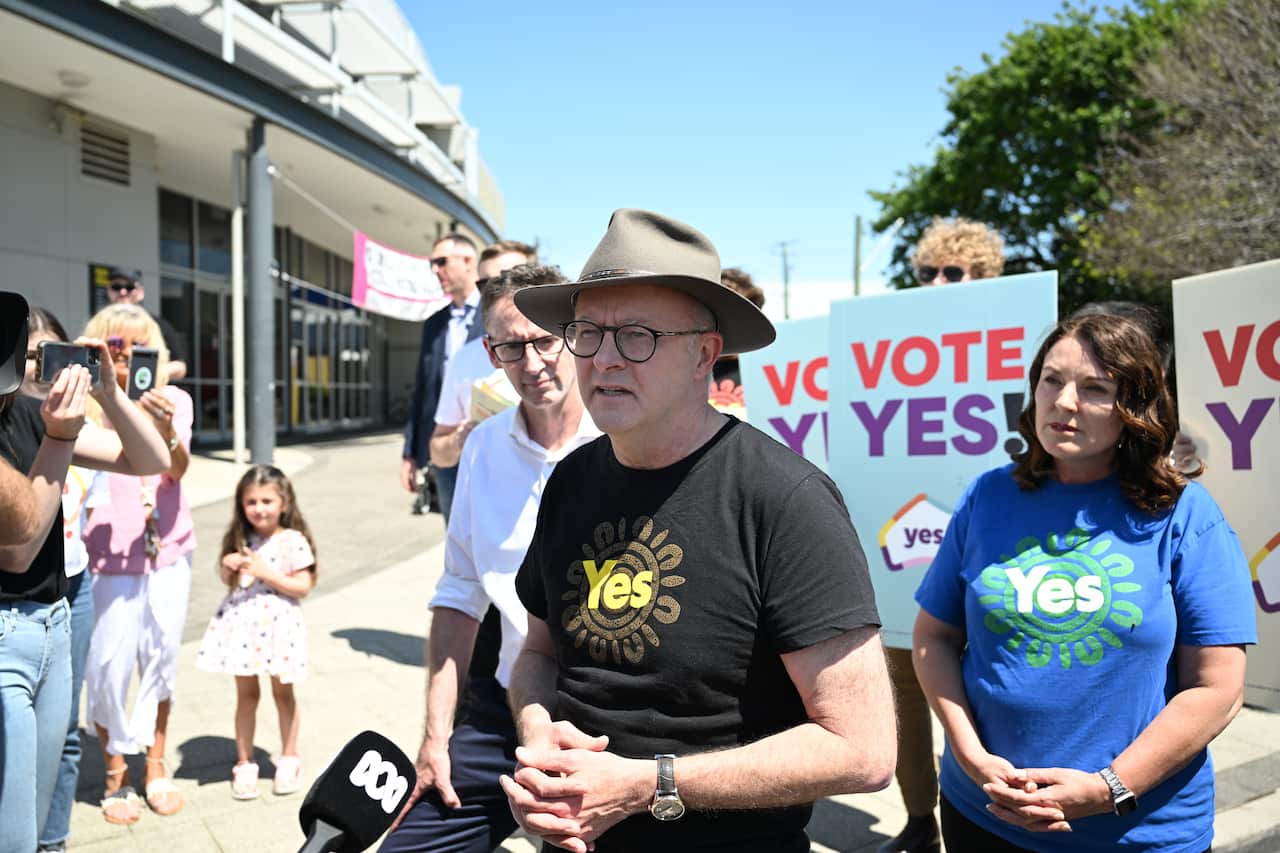 A man speaks to reporters.