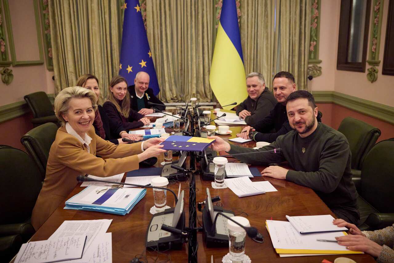 Leaders sitting at a table with documents.
