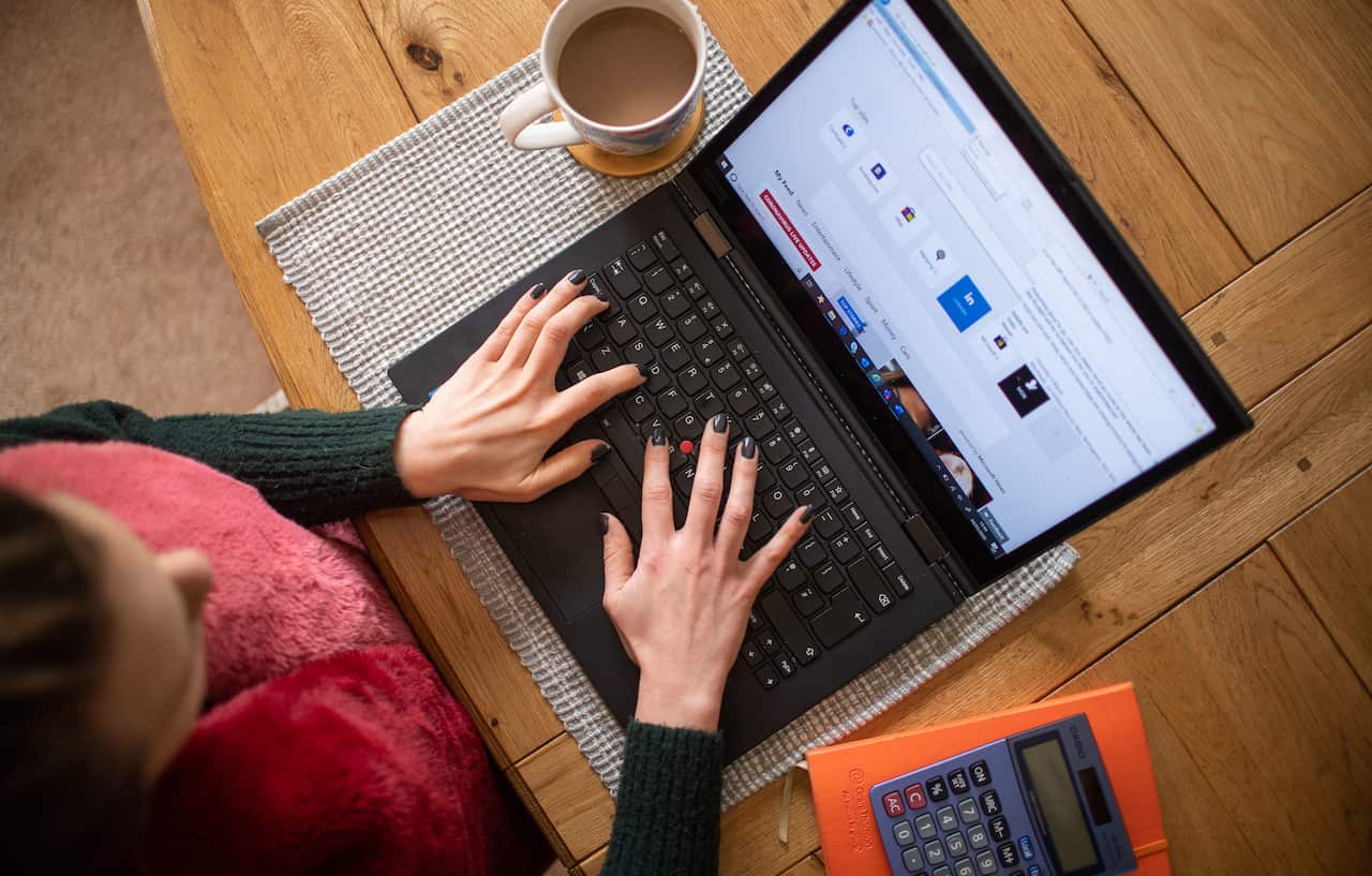 A woman typing on a laptop computer