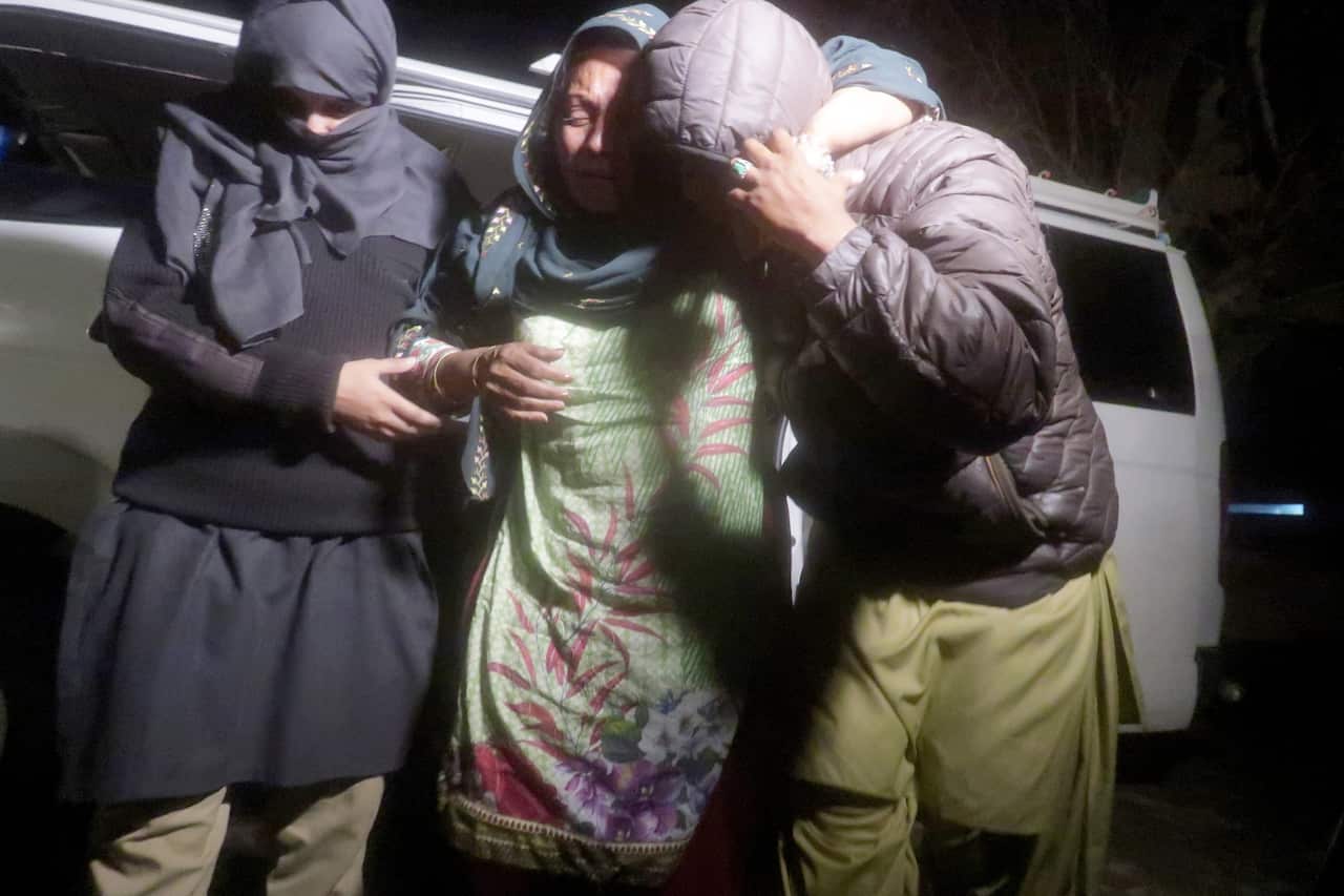 A woman is being rescued by security forces.