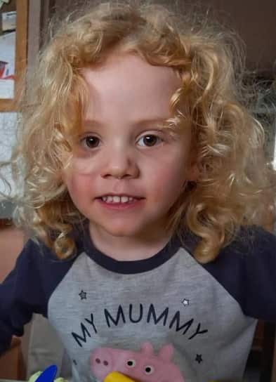 A boy with curly blond hair.