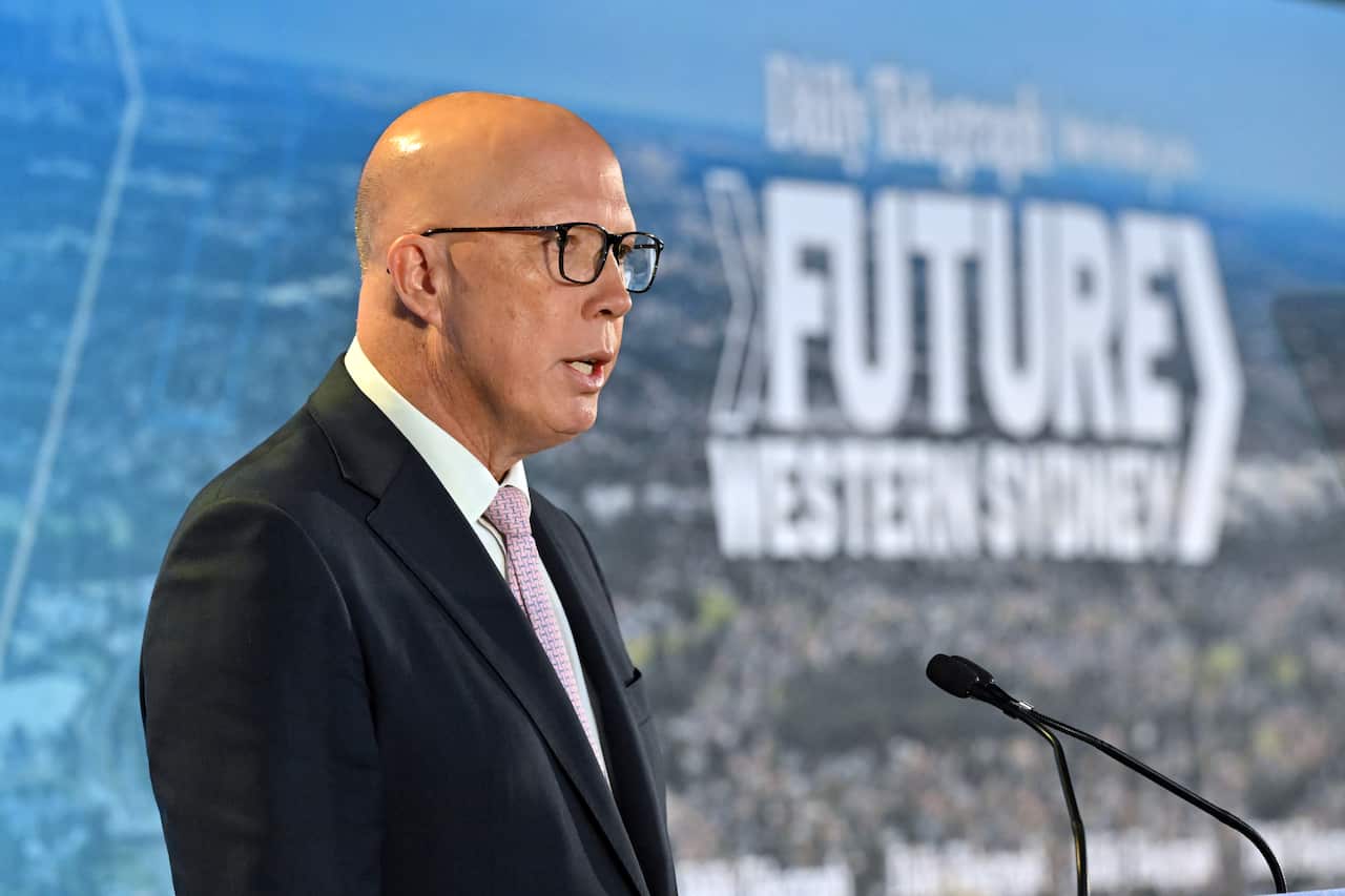 Peter Dutton speaks into a microphone. 