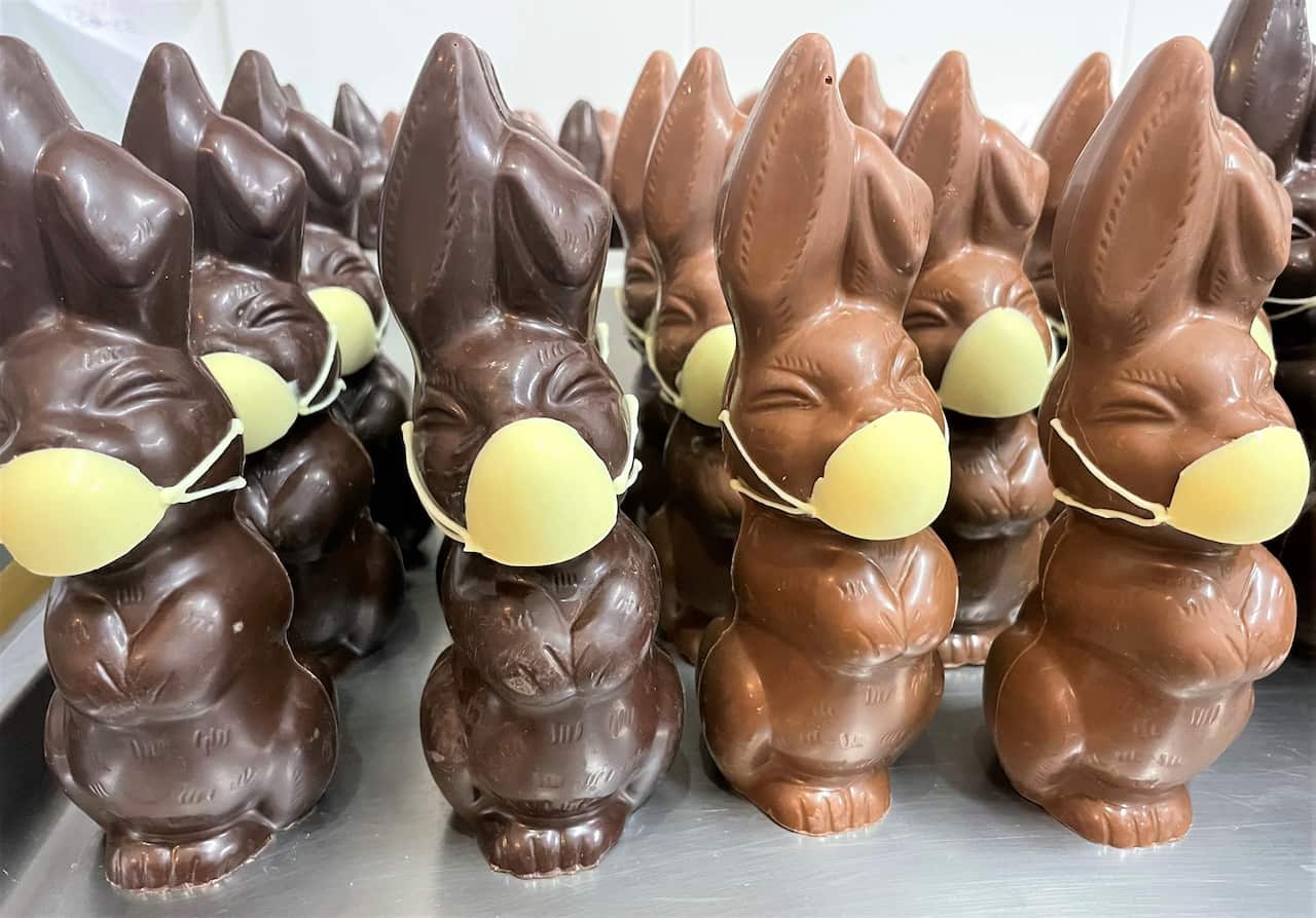 Dark and milk chocolate rabbits featuring white chocolate face masks.