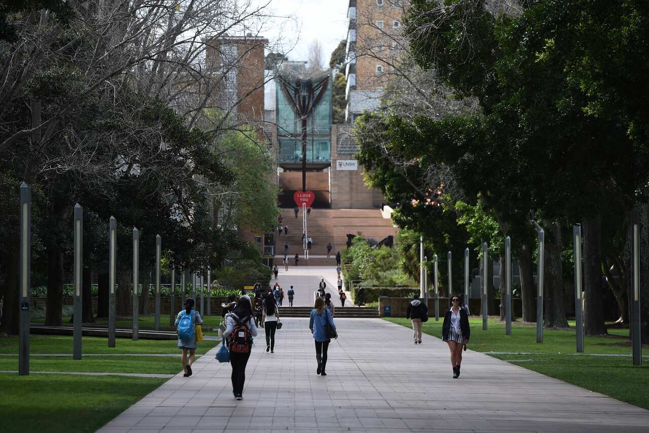 People walking on the grounds of a university.