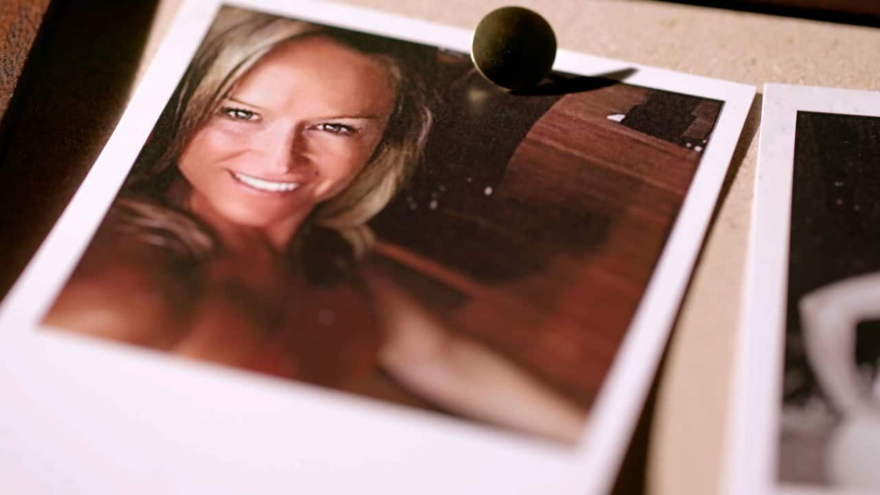 A Polaroid photo of a woman with blonde hair smiling while taking a selfie.