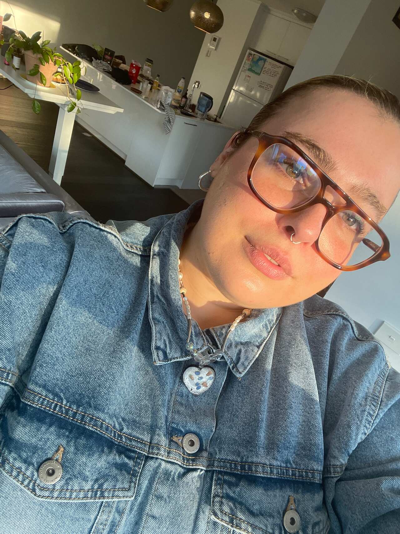 A selfie of a young woman in her house