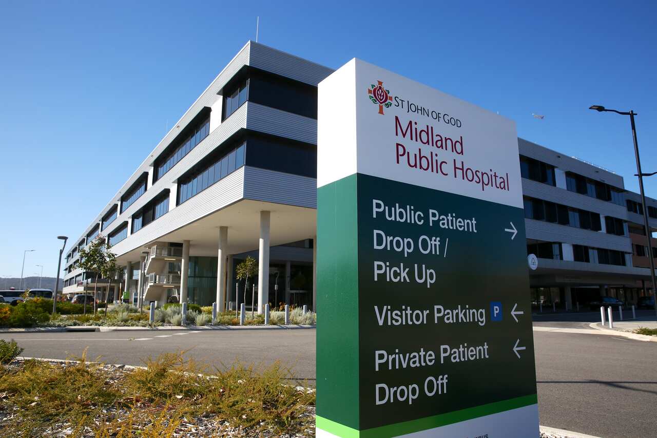 St John of God Midland Public Hospital signage with the hospital building in the background.