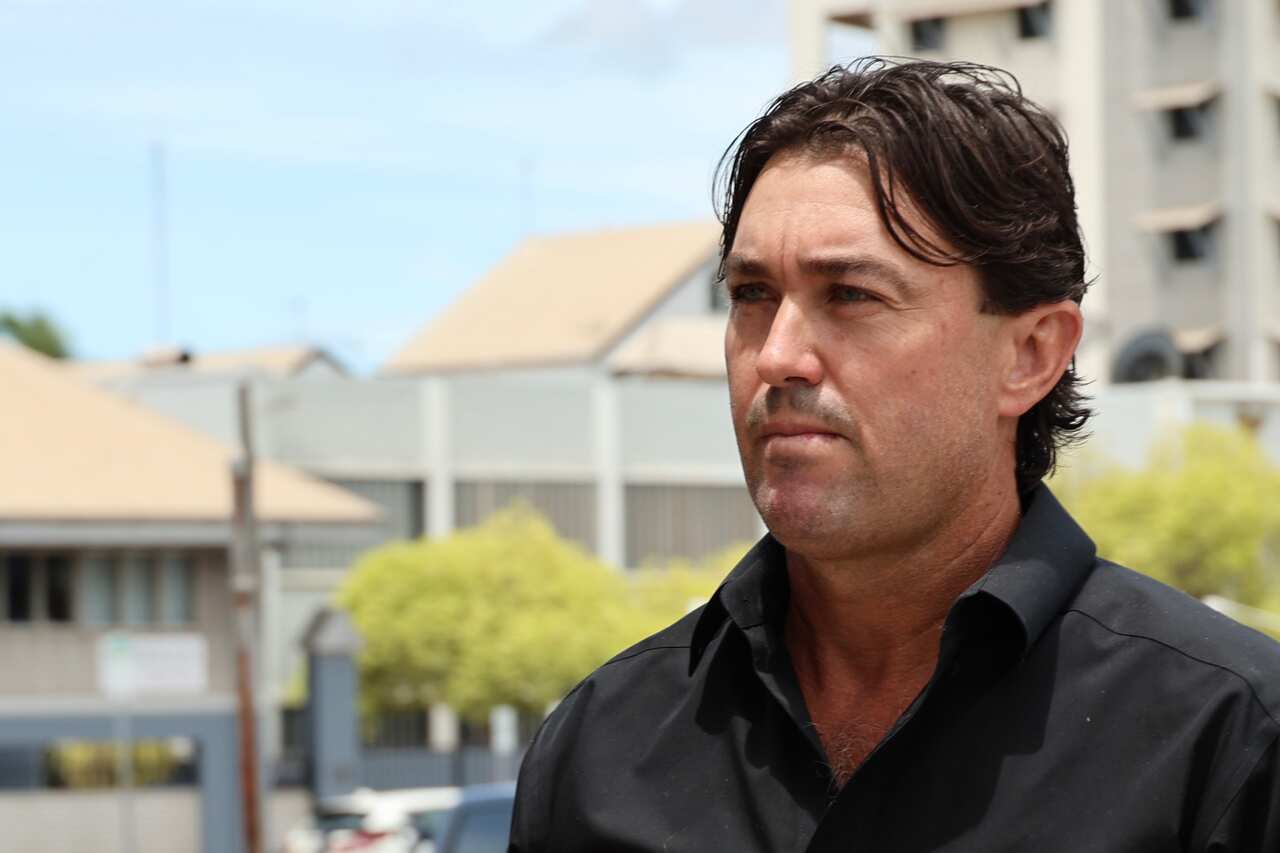 A man in a black shirt outside court