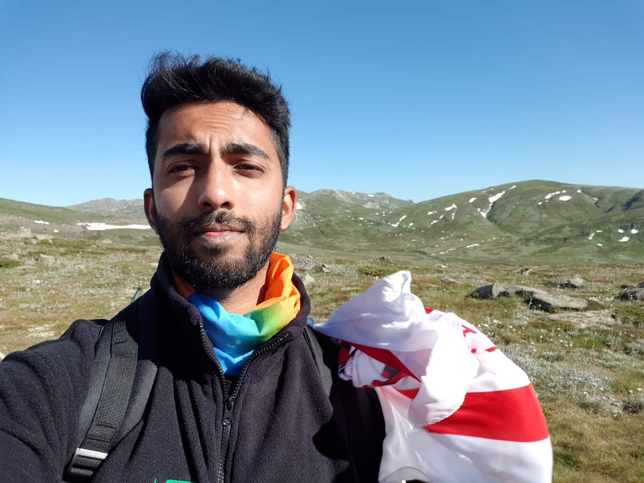 Man standing outside amongst mountains