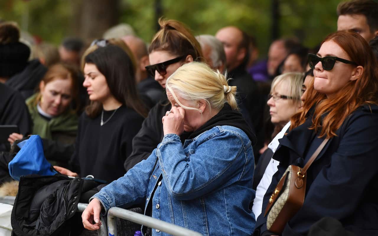 Mourners get emotional at Westminster Abbey before the state funeral service of Britain's Queen Elizabeth II.