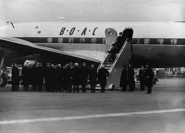 Queen Elizabeth descends steps of aeroplane in 1952.