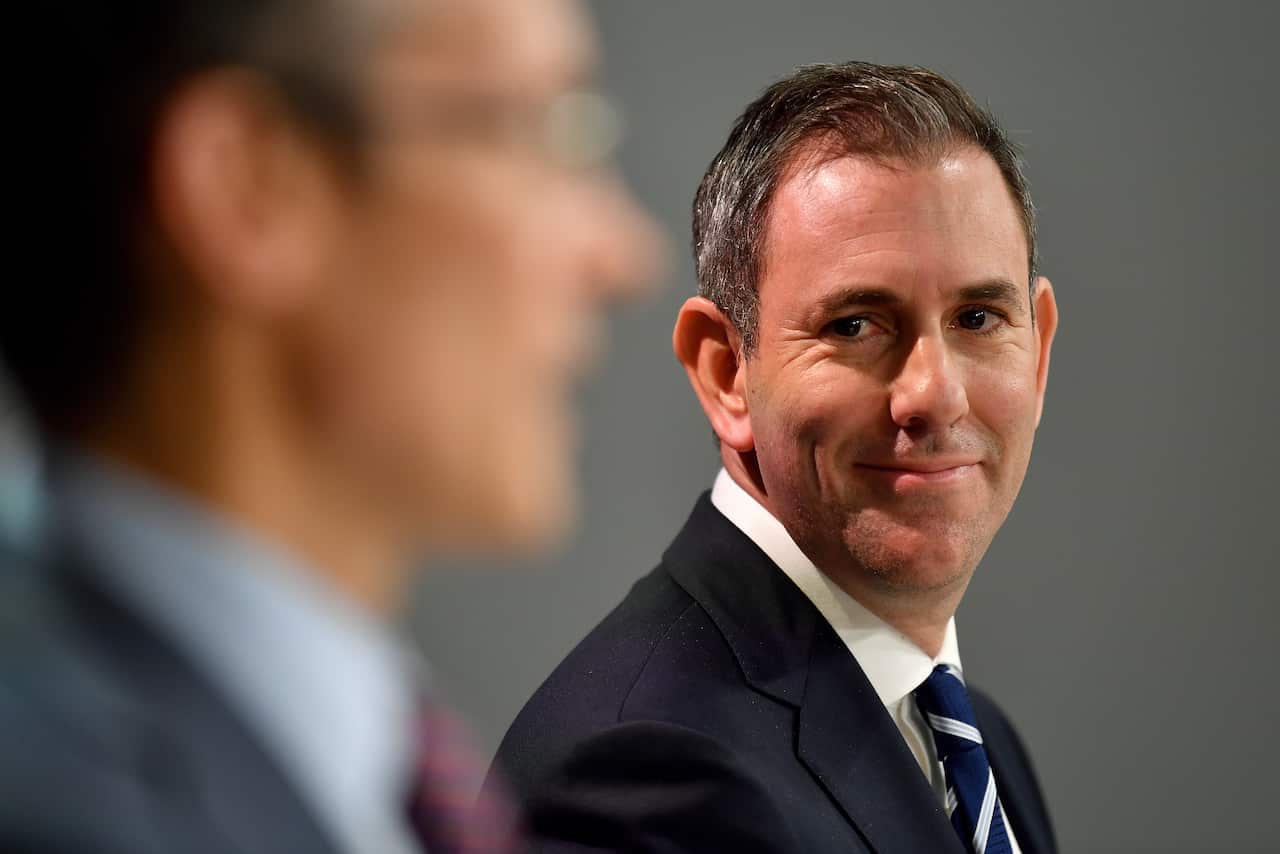 Man is suit and tie smiles.